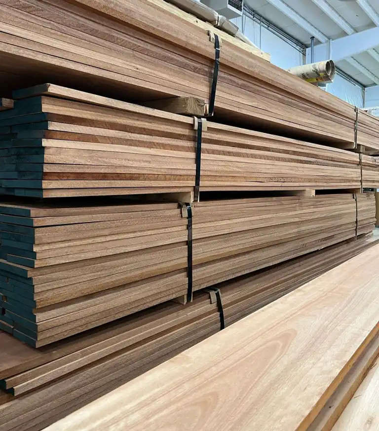 Stacked lumber boards bundled with straps in a warehouse